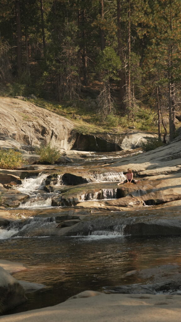 Girl sitting by the river at Tenmile Creek